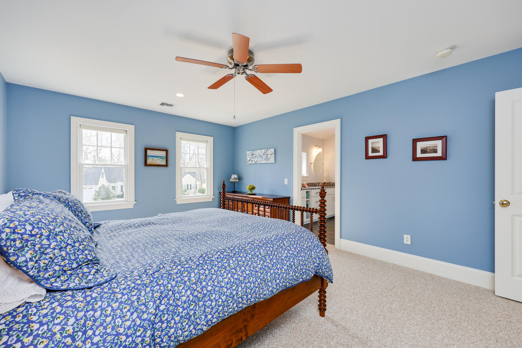 40 Reflection Drive Sandwich, MA 02563 - Photo 38 of 59 a bedroom with a large bed and a chandelier