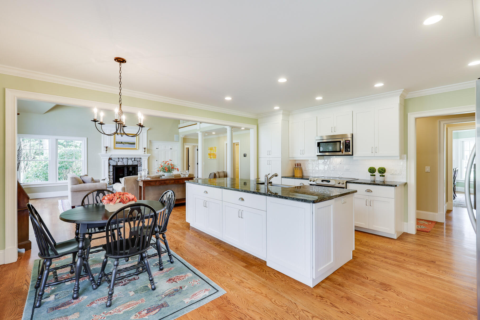 40 Reflection Drive Sandwich, MA 02563 - Photo 8 of 59 a kitchen with stainless steel appliances granite countertop a stove top oven a sink dishwasher a dining table and chairs with wooden floor