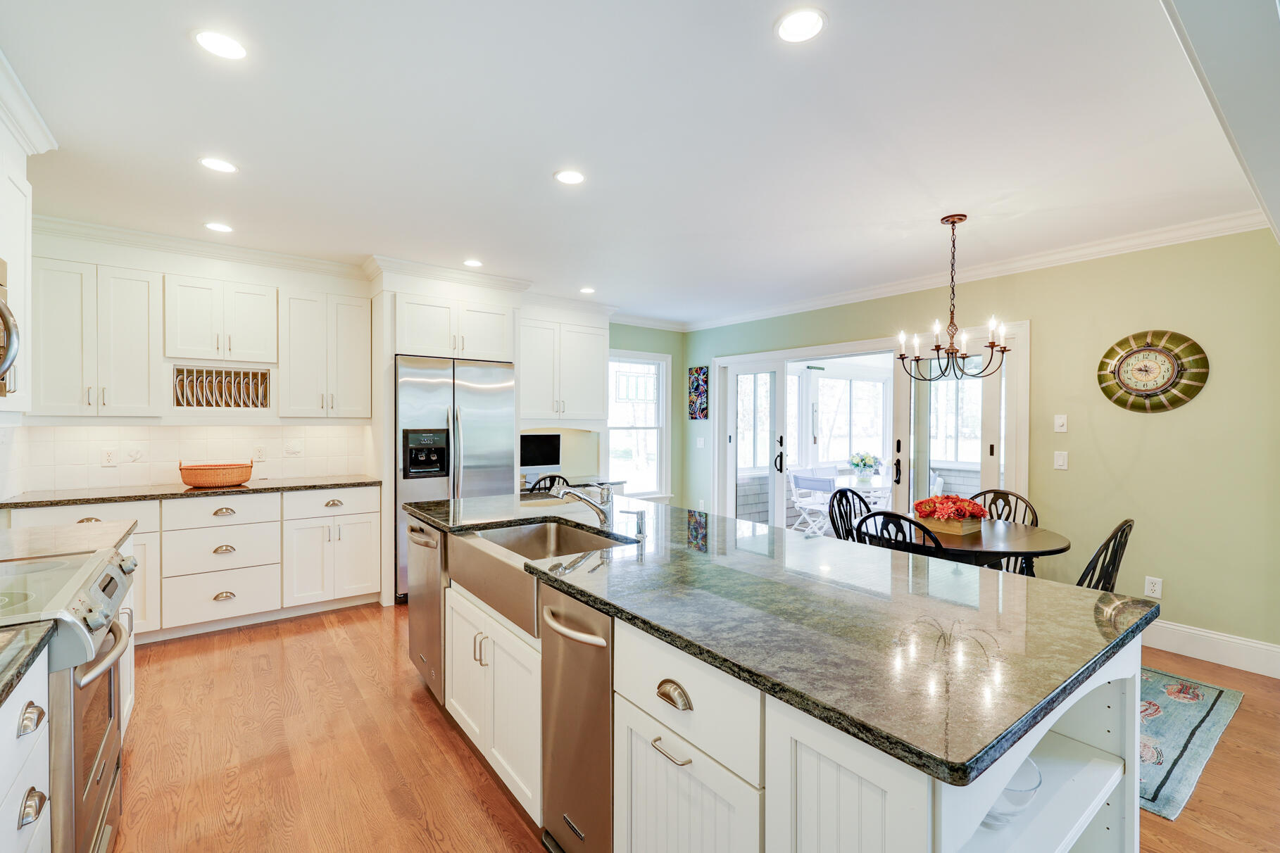 40 Reflection Drive Sandwich, MA 02563 - Photo 9 of 59 a kitchen with stainless steel appliances granite countertop a stove a sink a refrigerator and white cabinets with wooden floor