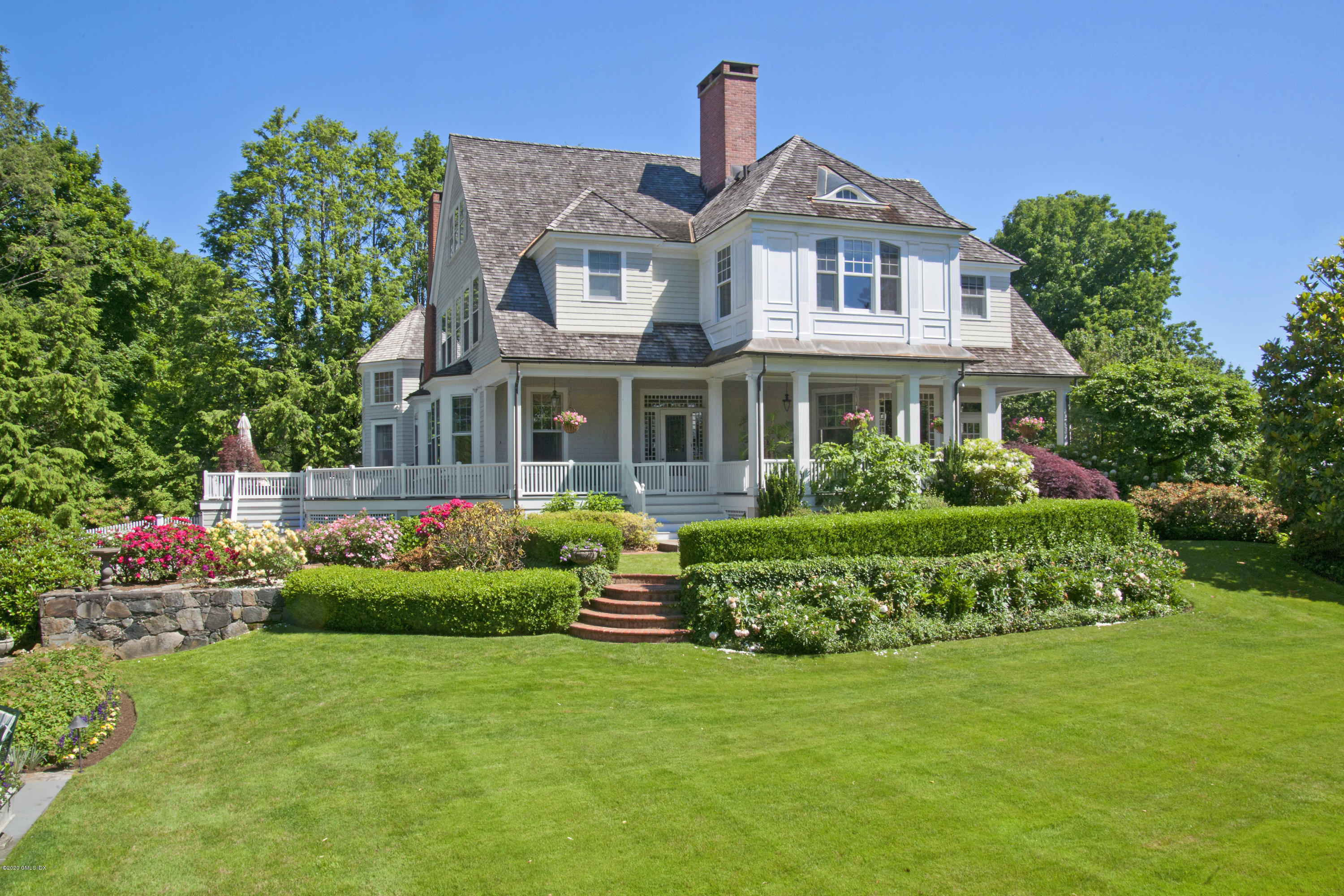 134 Otter Rock Drive Greenwich, CT 06830 - Photo 5 of 25 a front view of house with yard and green space