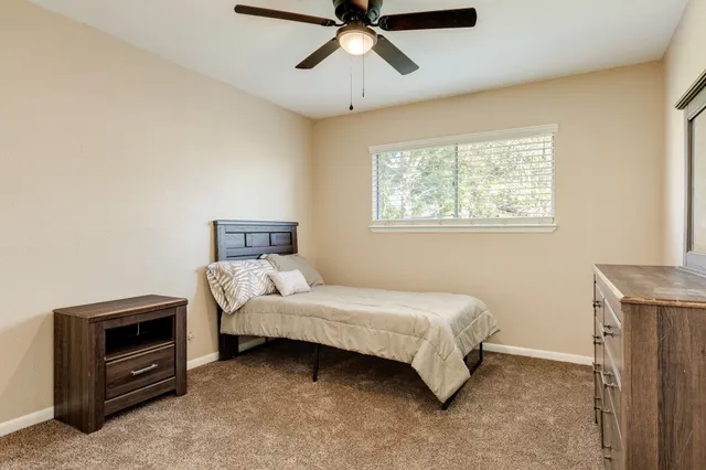 a bedroom with a bed and a tv