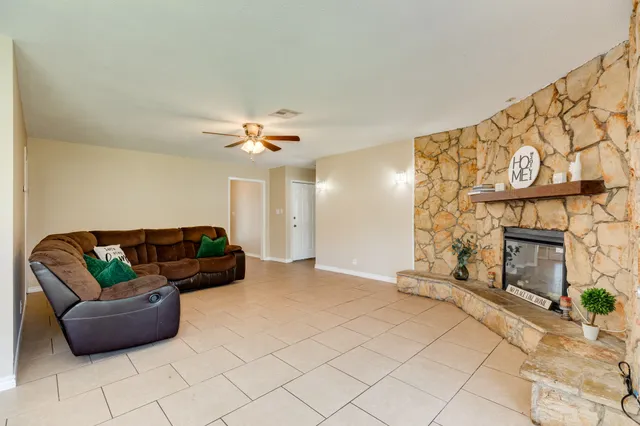a living room with furniture and a fireplace