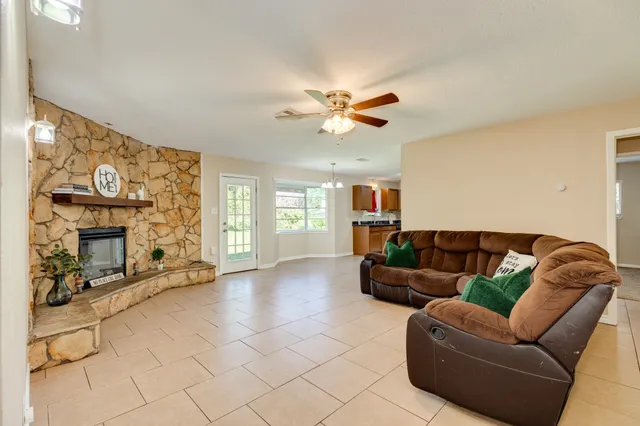 a living room with furniture and a fireplace