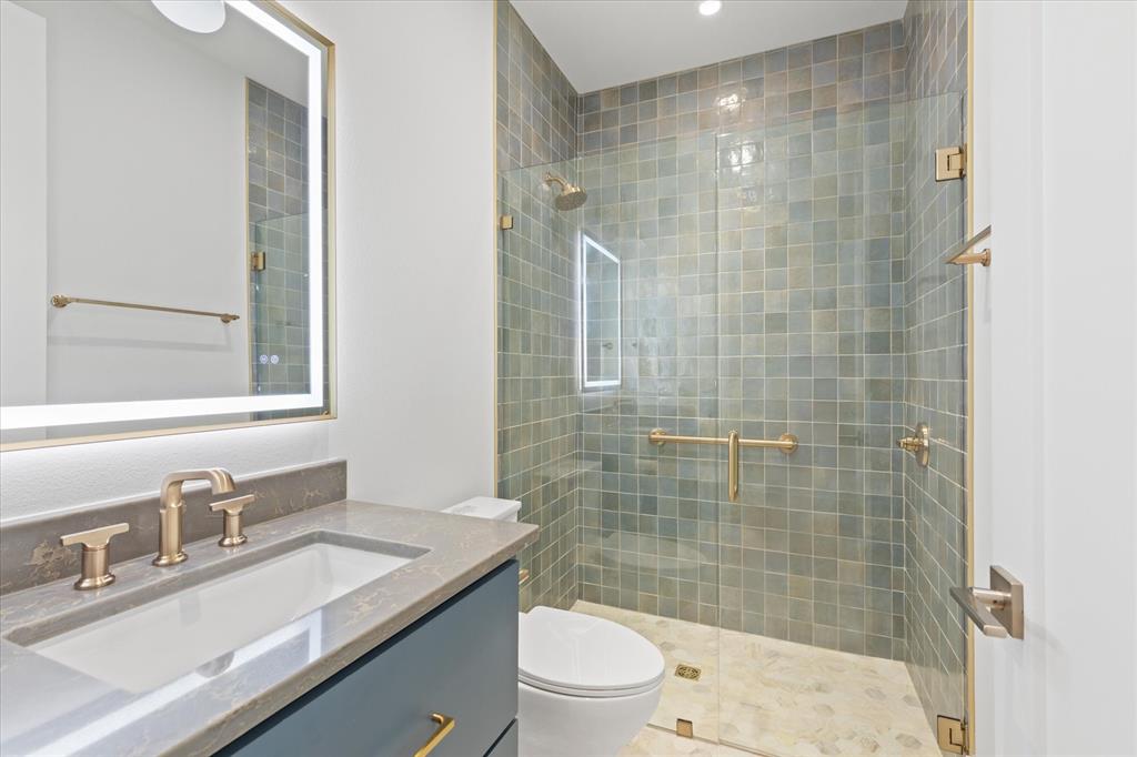 426 Lost Pittsburg, TX 75686 - Photo 27 of 40 a bathroom with a sink a toilet a mirror and shower