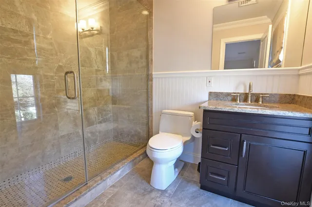 a bathroom with a toilet sink and a shower