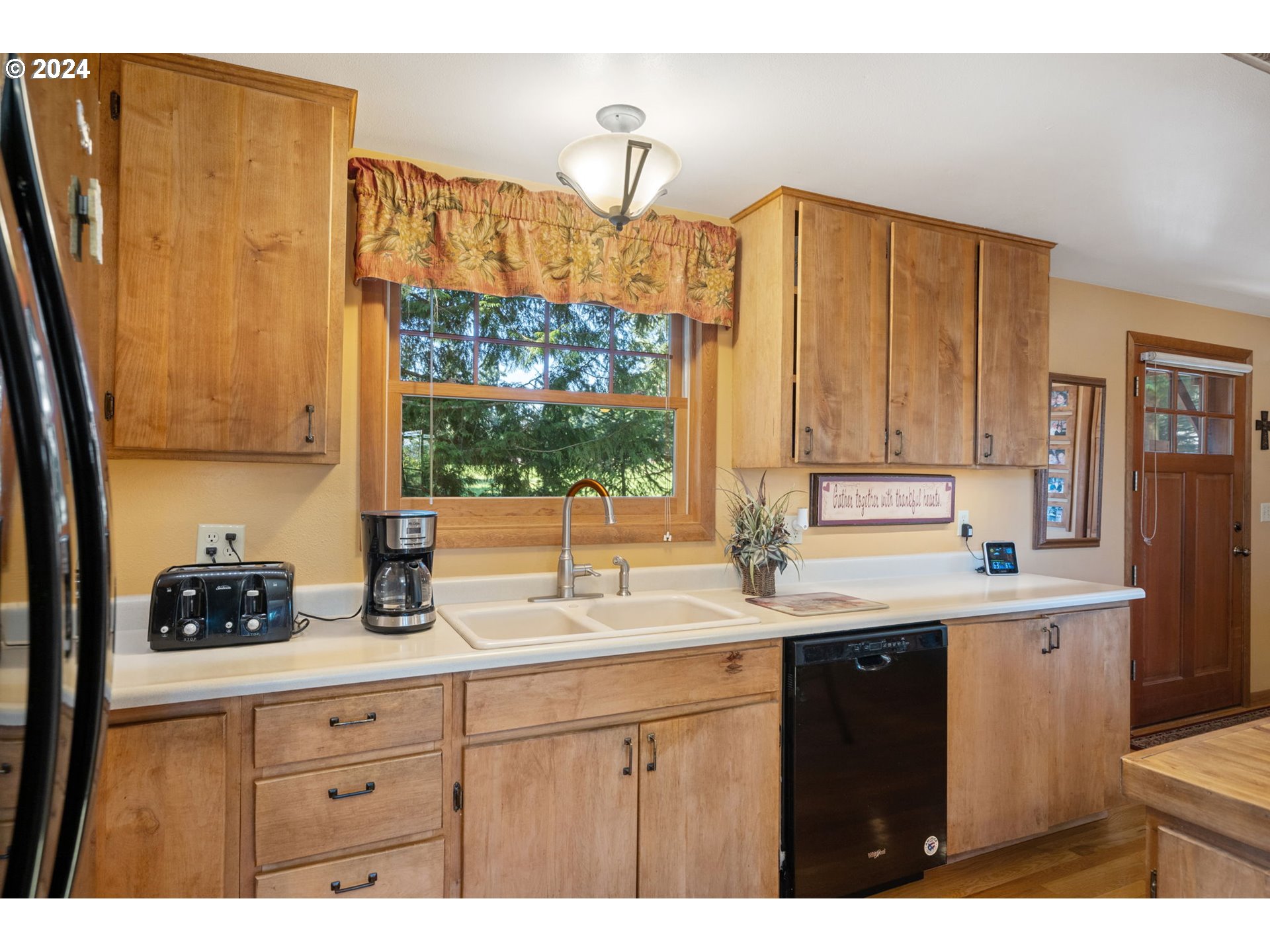 16441 South Henrici Road Oregon City, OR 97045 - Photo 9 of 41 a kitchen with a sink a window and cabinets