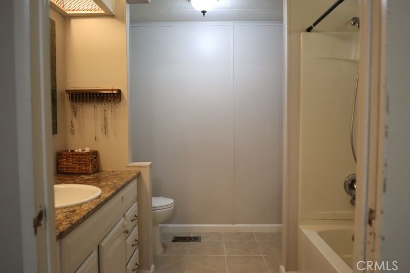 34164 Harrow Hill Road Wildomar, CA 92595 - Photo 23 of 60 a bathroom with a granite countertop sink toilet and shower
