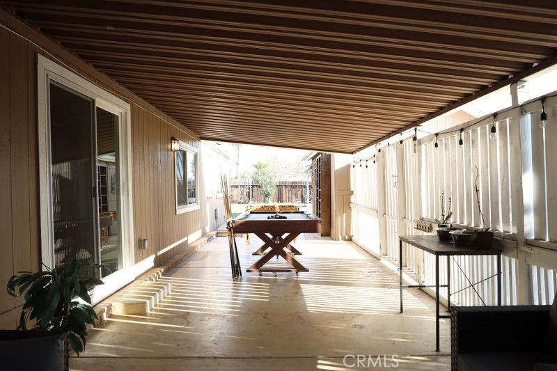 34164 Harrow Hill Road Wildomar, CA 92595 - Photo 30 of 60 a view of a patio with a table and chairs and wooden floor