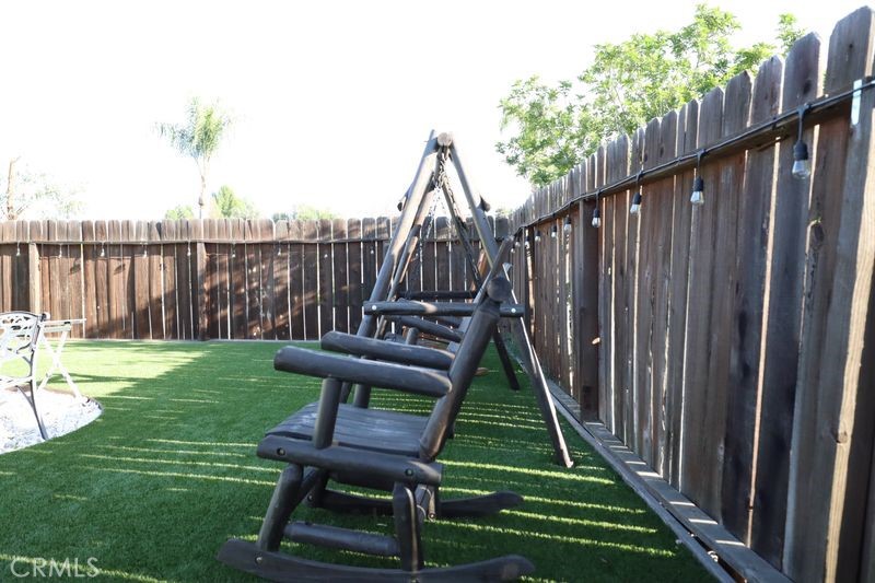 34164 Harrow Hill Road Wildomar, CA 92595 - Photo 47 of 60 a view of a deck with a table and chair swing