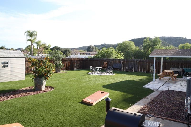 34164 Harrow Hill Road Wildomar, CA 92595 - Photo 49 of 60 a backyard of a house with table and chairs