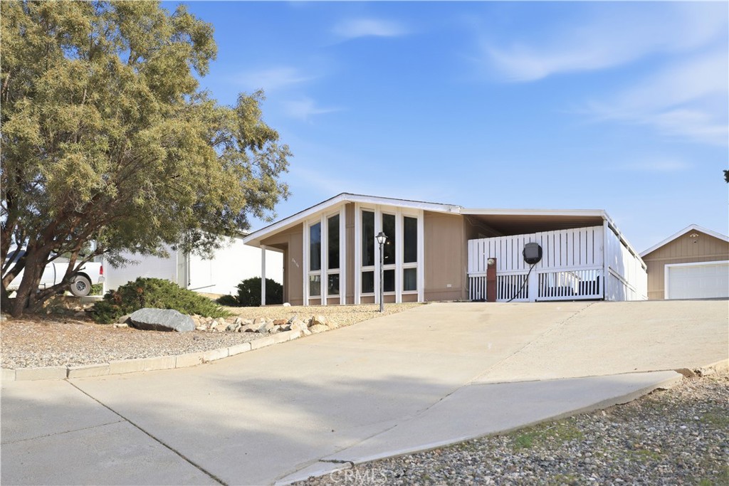 34164 Harrow Hill Road Wildomar, CA 92595 - Photo 58 of 60 a tall building with a large tree in front of it