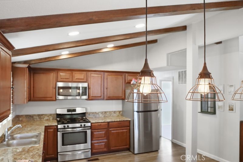 34164 Harrow Hill Road Wildomar, CA 92595 - Photo 6 of 60 a kitchen with stainless steel appliances a refrigerator and a stove top oven