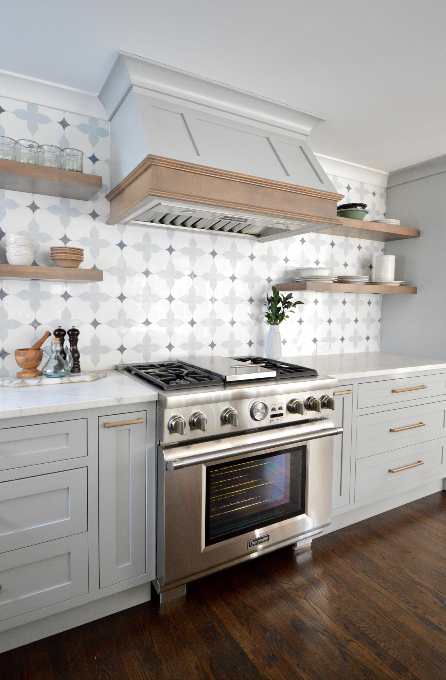 a stove top oven sitting inside of a kitchen