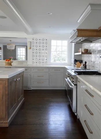 a kitchen with granite countertop a sink a counter space appliances and cabinets