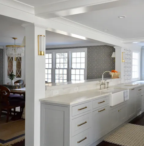 a living room with furniture a window and chandelier