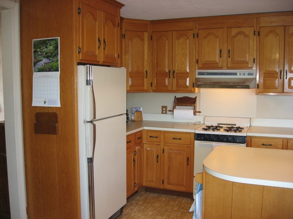 147 Lake Road Brookfield, MA 01506 - Photo 17 of 38 a kitchen with a refrigerator and a stove top oven