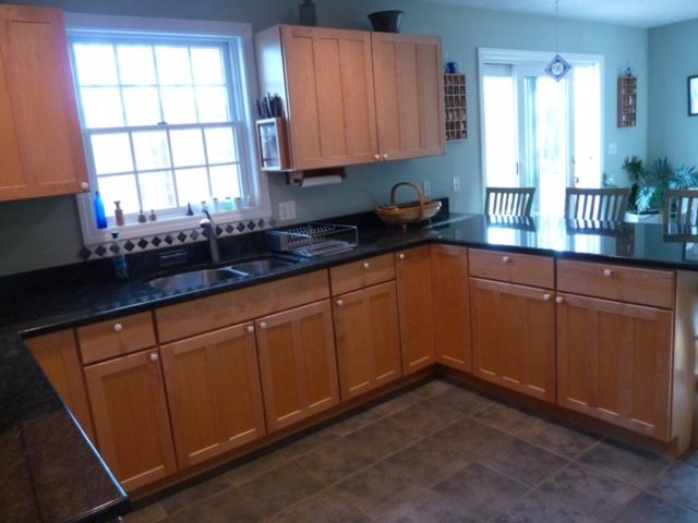 6 Farm Path Road Edgartown, MA 02539 - Photo 3 of 14 a kitchen with stainless steel appliances granite countertop wooden cabinets a sink and a window