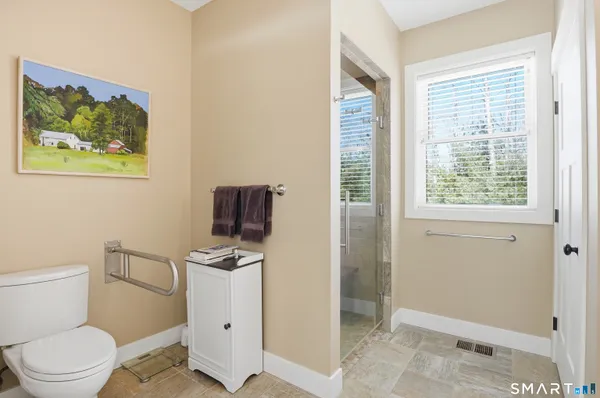 a bathroom with a toilet a sink and a shower