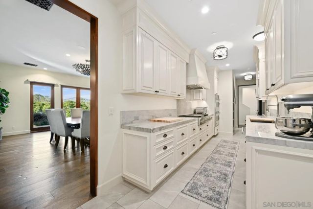a living room with couches a fireplace with wooden floor