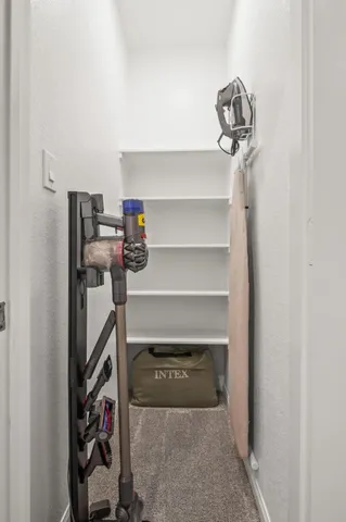 a view of storage and utility room with racks on the wall