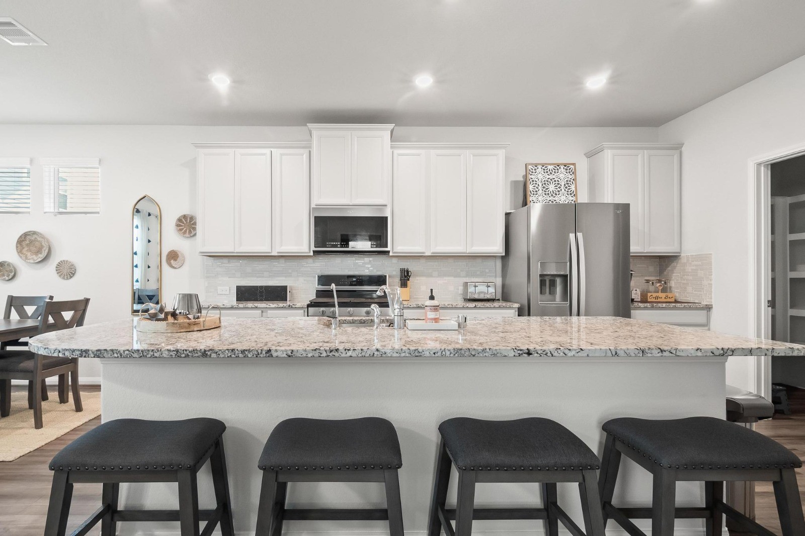 5511 Cuerta Street Houston, TX 77023 - Photo 3 of 25 a kitchen with stainless steel appliances granite countertop a table chairs microwave and sink
