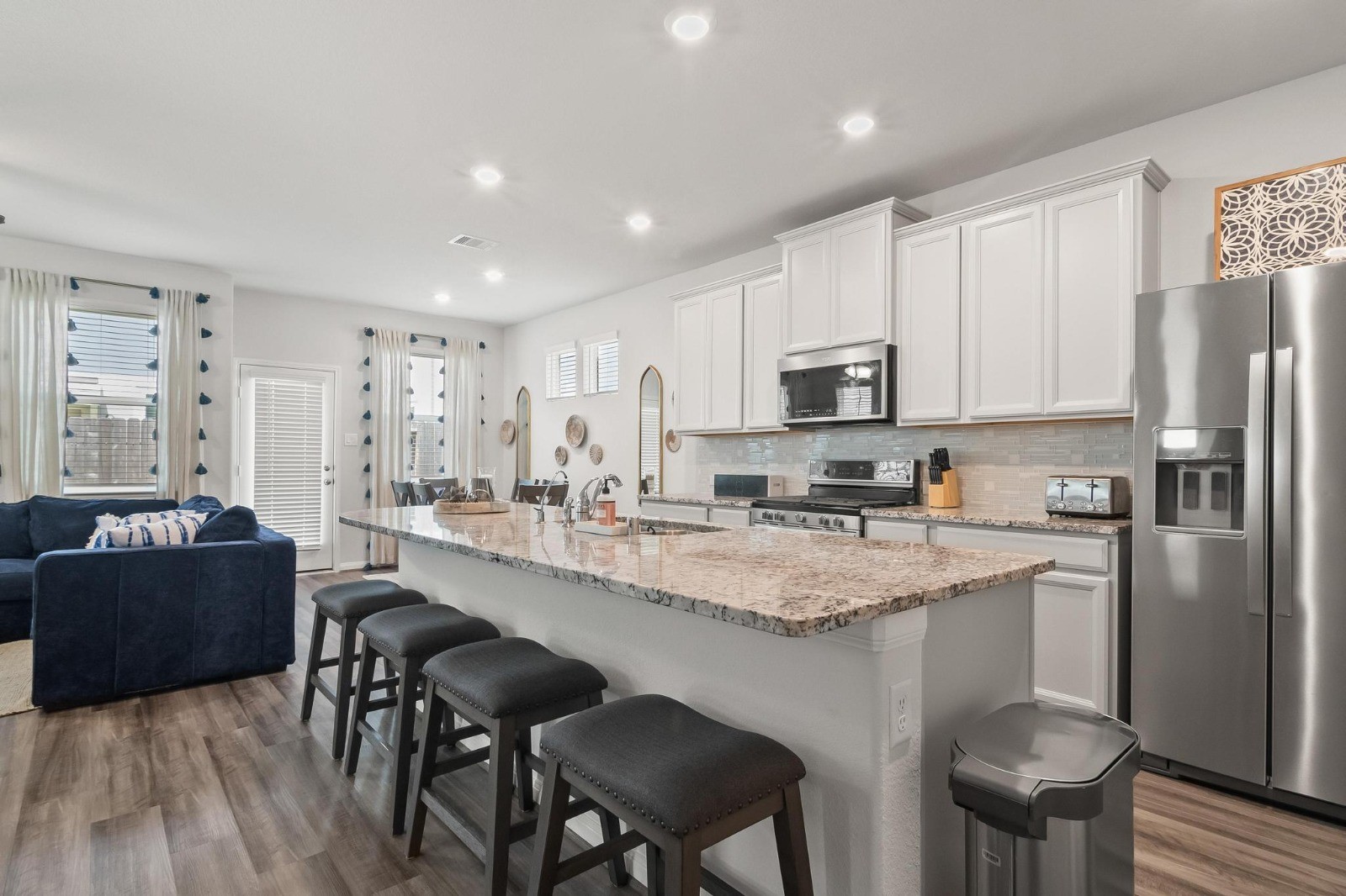 5511 Cuerta Street Houston, TX 77023 - Photo 4 of 25 a kitchen with stainless steel appliances granite countertop a stove a sink a microwave a refrigerator and cabinets