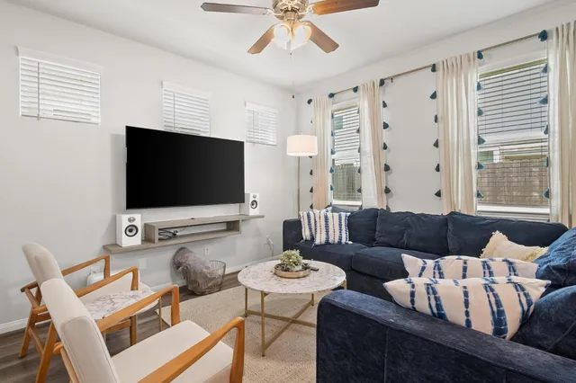 a living room with furniture and a flat screen tv