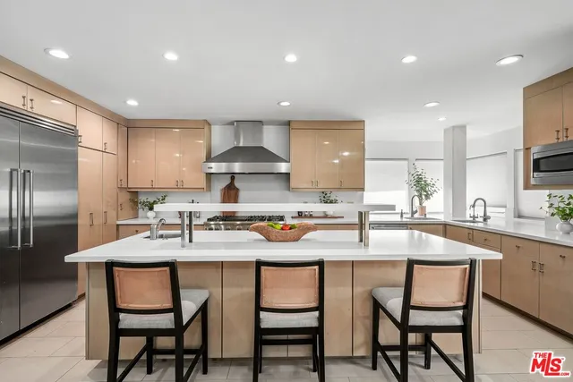 a kitchen with granite countertop counter space dining table and stainless steel appliances