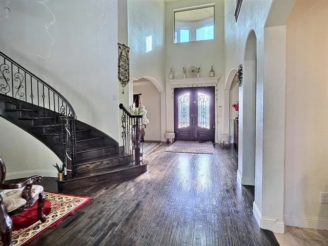 a view of entryway and hall with wooden floor