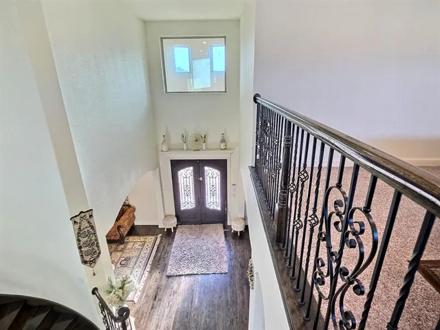 a view of a hallway with wooden floor and closet