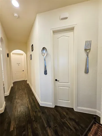 a living room with furniture a flat screen tv and a chandelier
