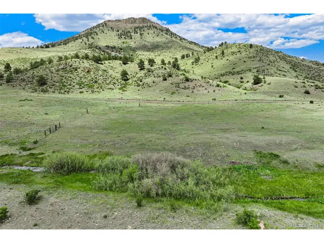 a view of a lush green hillside and mountain view