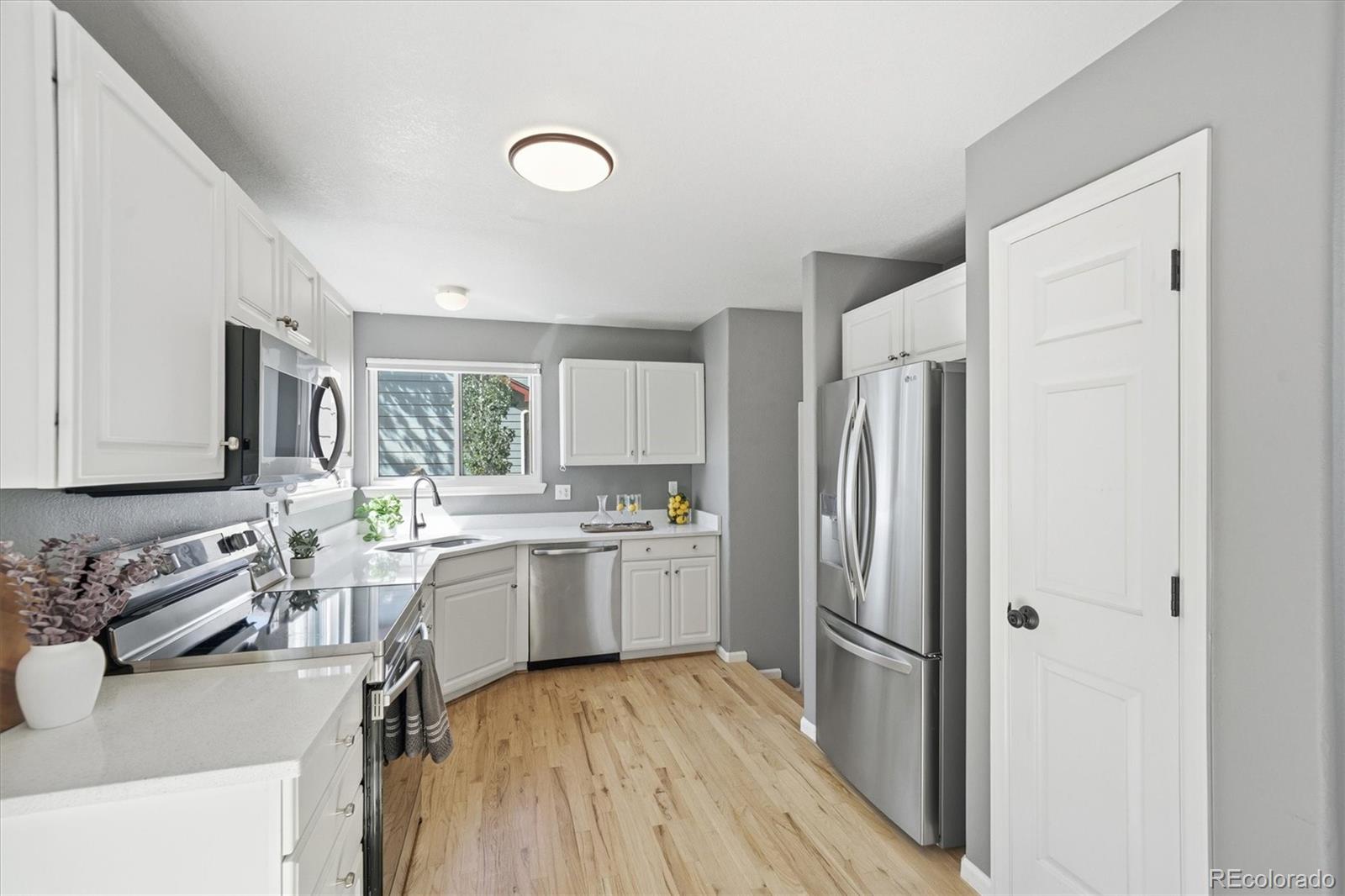 9629 Burberry Way Highlands Ranch, CO 80129 - Photo 16 of 50 a kitchen with a sink stove and refrigerator