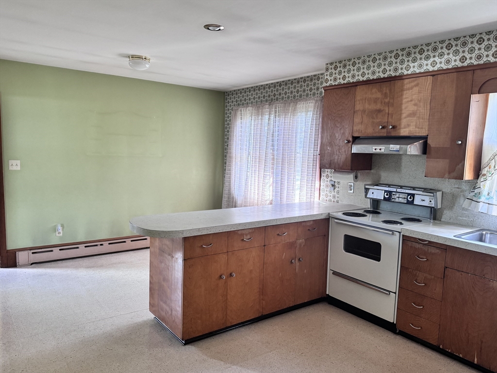 77 Grattan Street Fall River, MA 02721 - Photo 11 of 20 a kitchen with a stove and a sink
