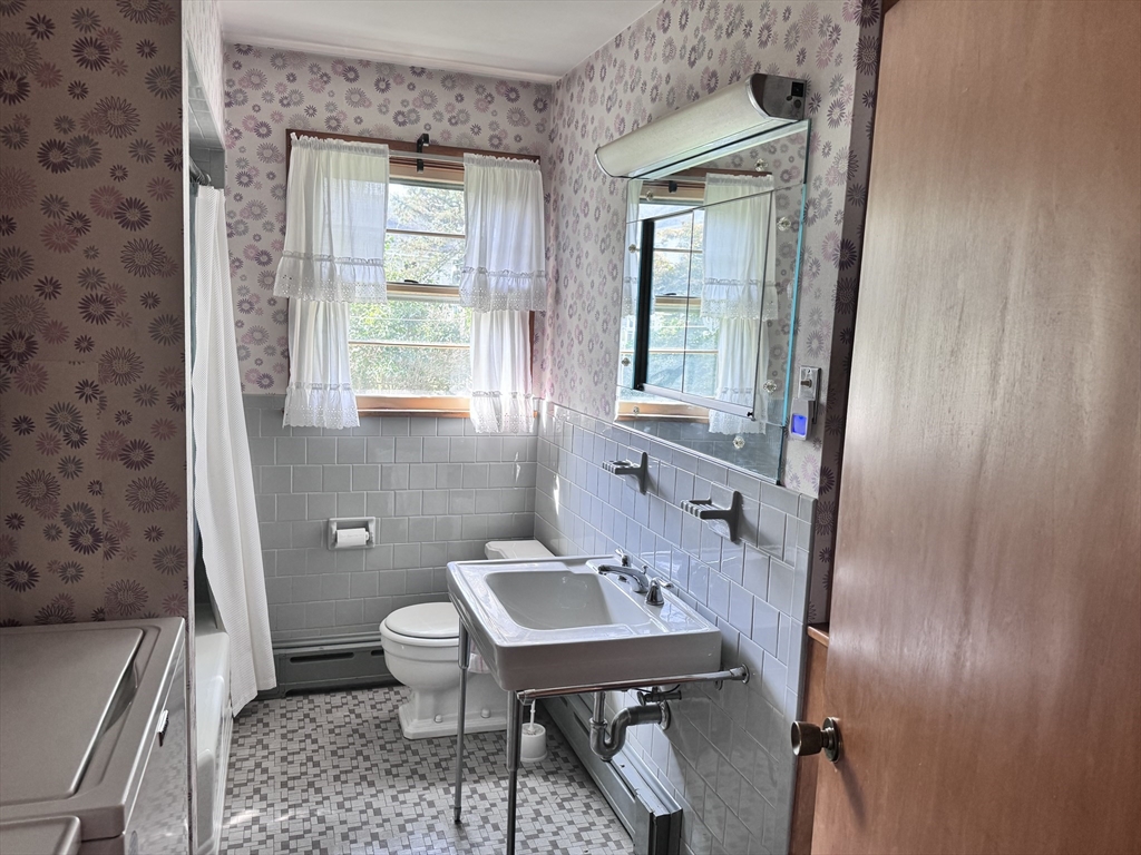 77 Grattan Street Fall River, MA 02721 - Photo 13 of 20 a bathroom with a sink a toilet and shower