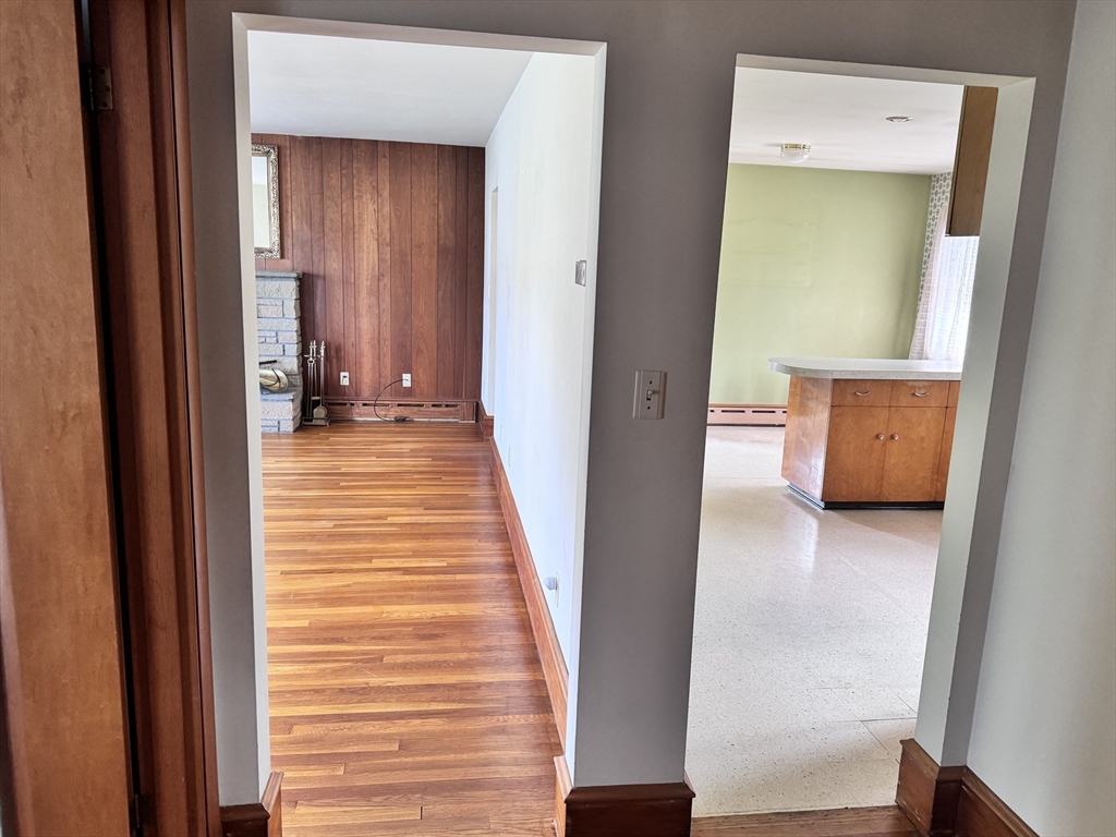 77 Grattan Street Fall River, MA 02721 - Photo 17 of 20 a view of a hallway with wooden floor and a cabinet