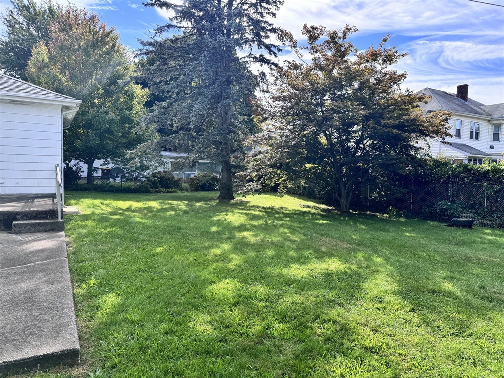 77 Grattan Street Fall River, MA 02721 - Photo 2 of 20 a swimming pool with wooden fence