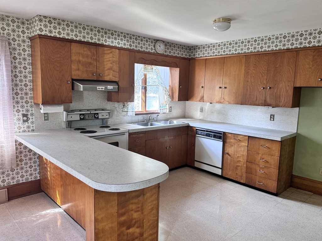 77 Grattan Street Fall River, MA 02721 - Photo 9 of 20 a kitchen with stainless steel appliances granite countertop a sink a stove and a refrigerator