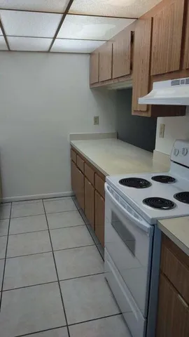 a kitchen with a stove and a cabinets