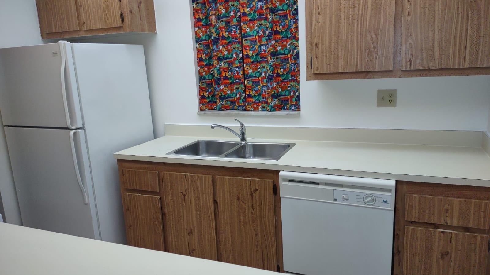 1950 North Congress Avenue, Unit J211 West Palm Beach, FL 33401 - Photo 7 of 7 a kitchen with a sink and a refrigerator