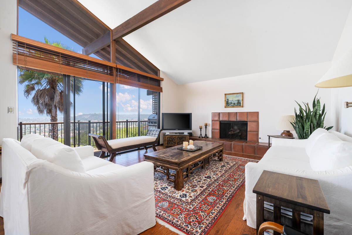 34 Rubio Road Santa Barbara, CA 93103 - Photo 5 of 10 a living room with furniture a fireplace and a floor to ceiling window