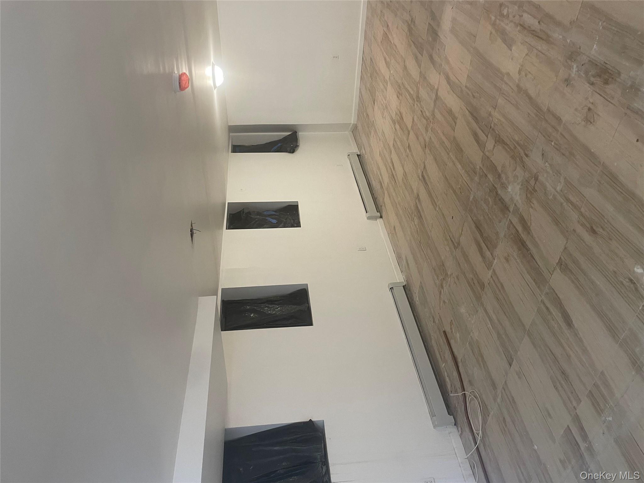 3418 Irwin Avenue Bronx, NY 10463 - Photo 13 of 19 a view of an empty room with wooden floor and windows