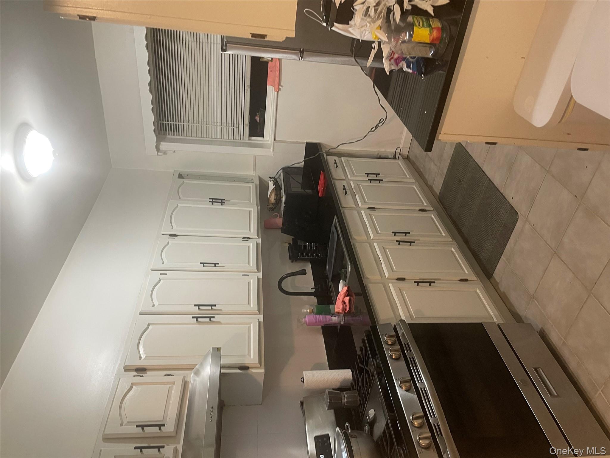 3418 Irwin Avenue Bronx, NY 10463 - Photo 4 of 19 a kitchen with granite countertop a sink stove and cabinets