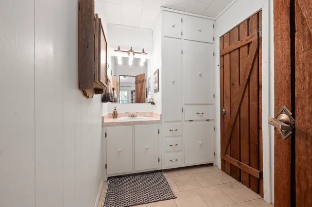 a bathroom with a sink a mirror and a shower