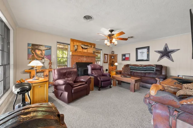 a living room with furniture a fireplace and a flat screen tv