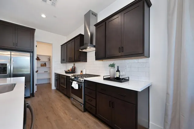 a kitchen with a sink stove and refrigerator