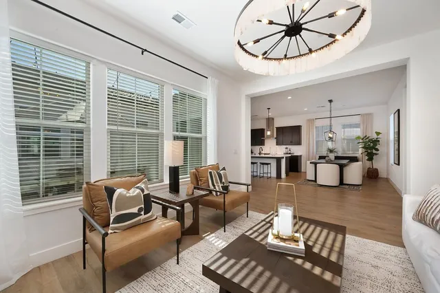 a living room with furniture a chandelier and a chandelier