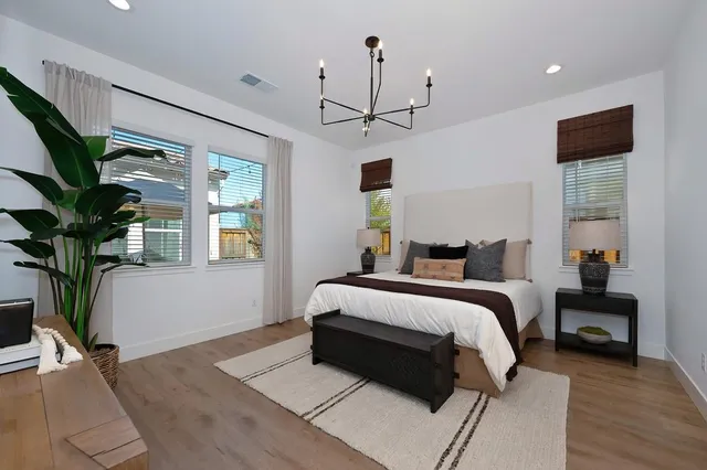 a bedroom with a bed and a view of kitchen