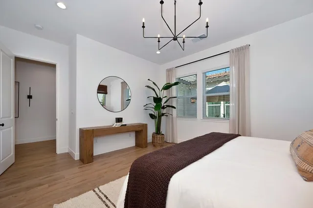 a bedroom with bed and a chandelier