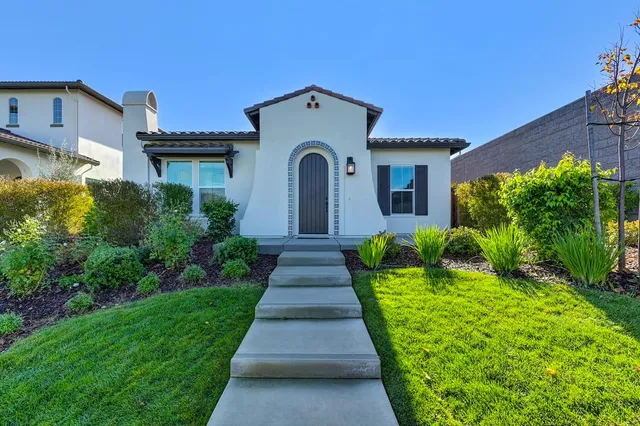 a front view of a house with a yard